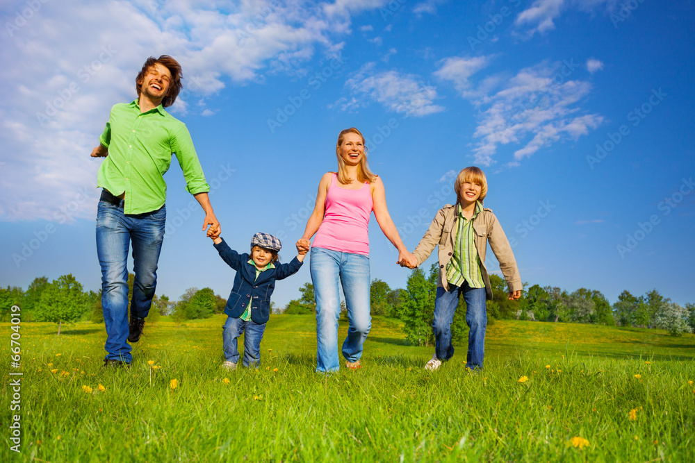 Cheerful parents walking with boys in park