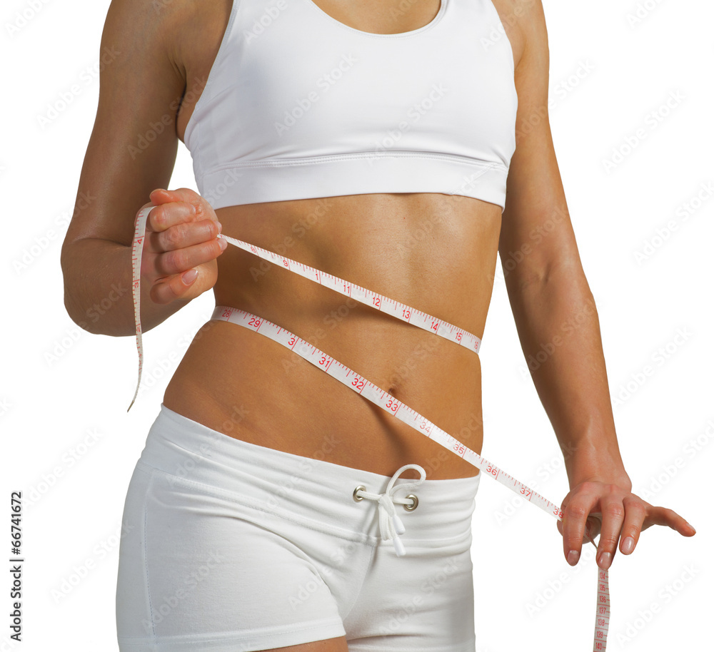 young athletic woman measuring waist