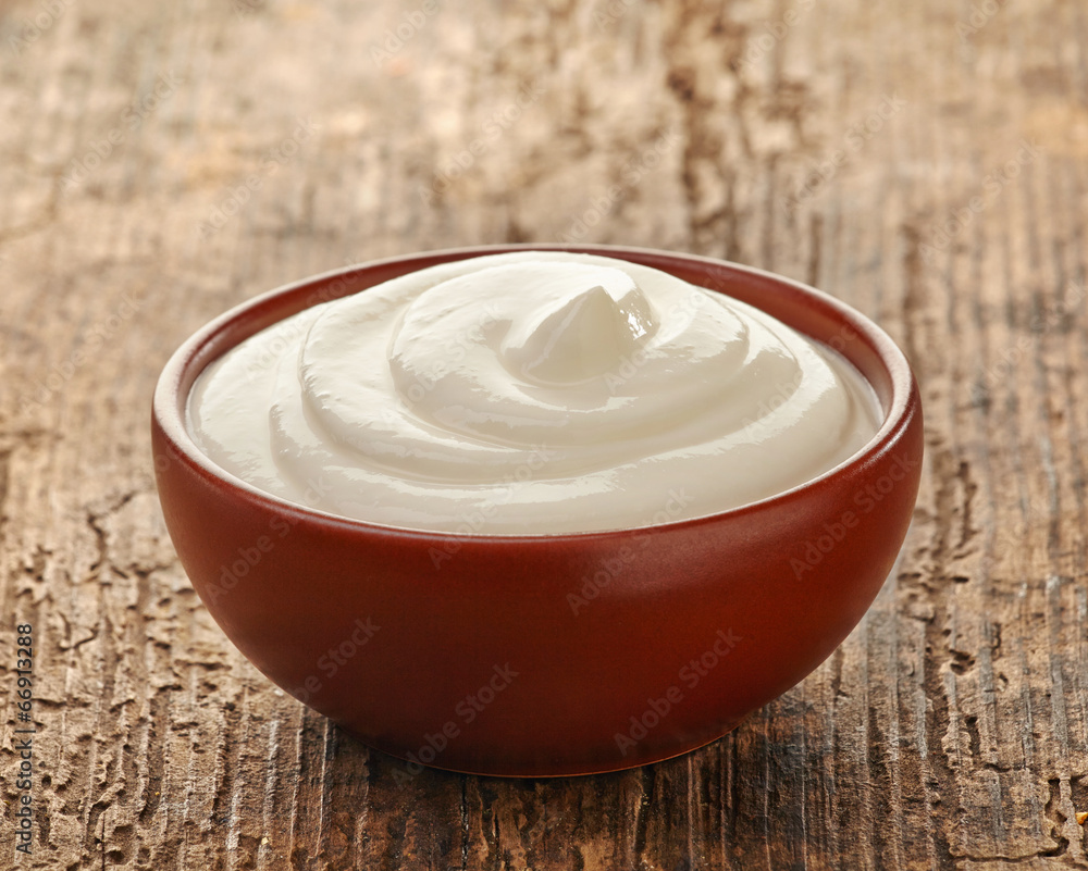 cream in a brown ceramic bowl