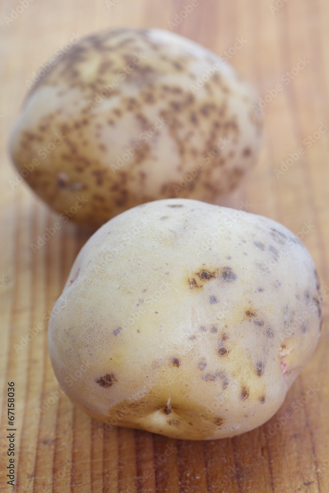 Small new potatoes on a wooden