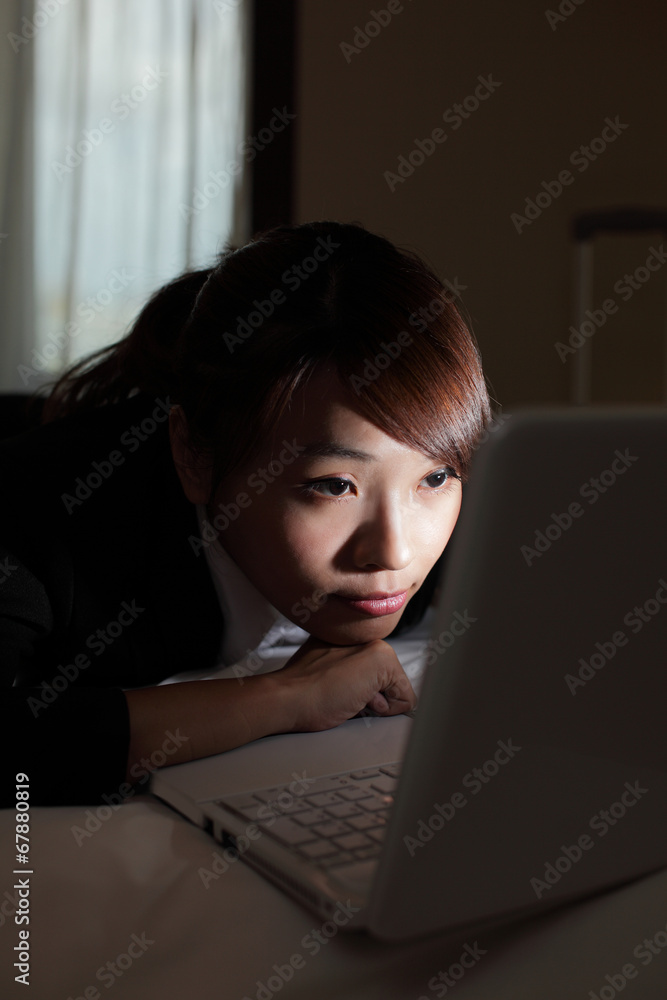 business woman look computer at night