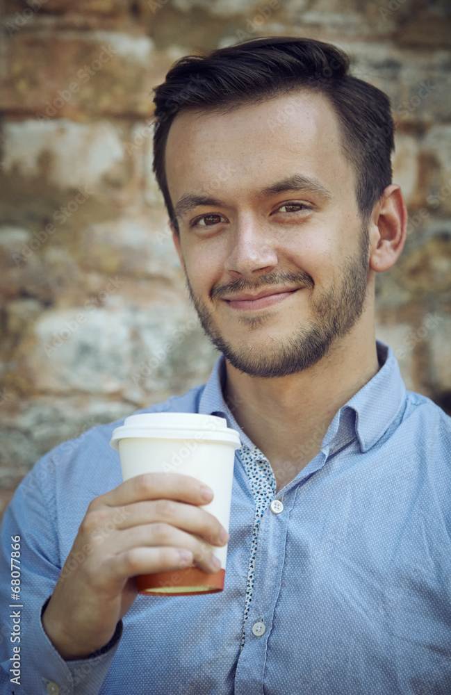 young man with cup of coffee