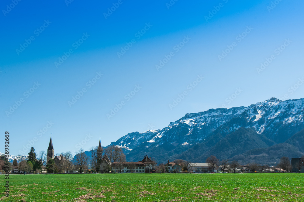 Beautiful scene of town with green field and trees at Interlaken