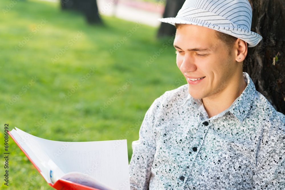 young man reading a book