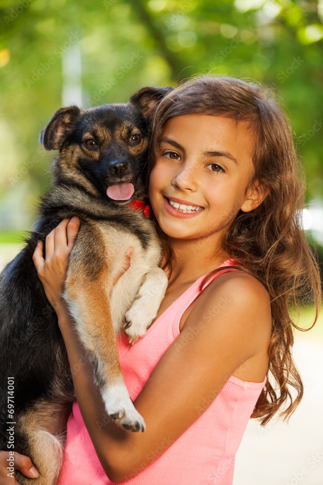 Teenage girl portrait in hugging little dog