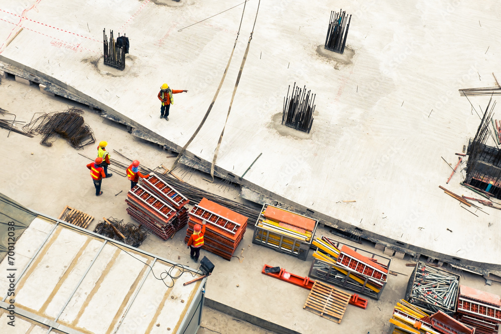 Construction workers working in site lifting tools