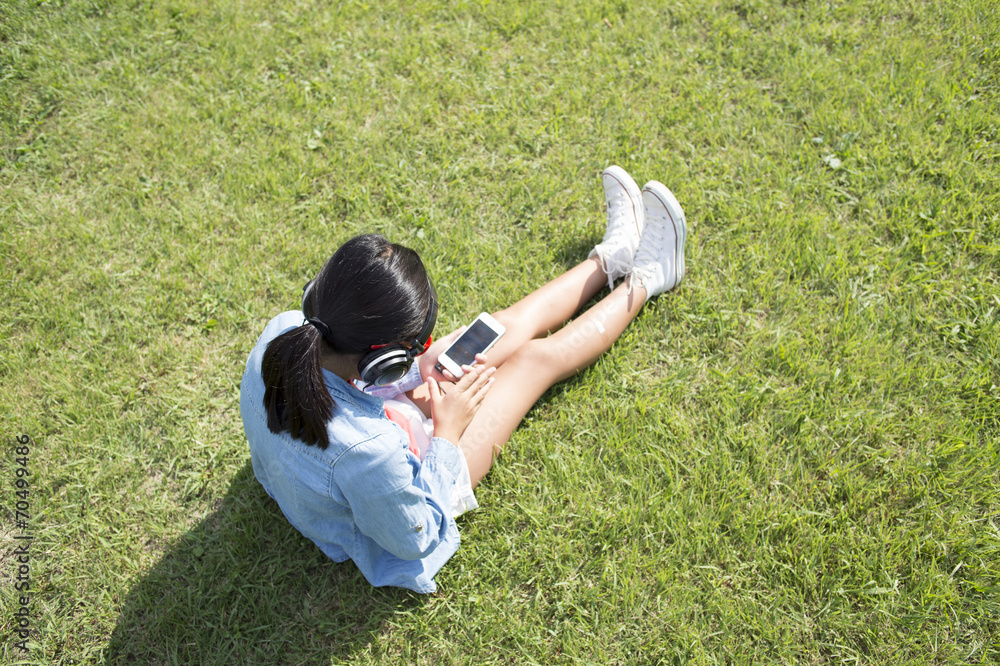 女孩在公园里听音乐