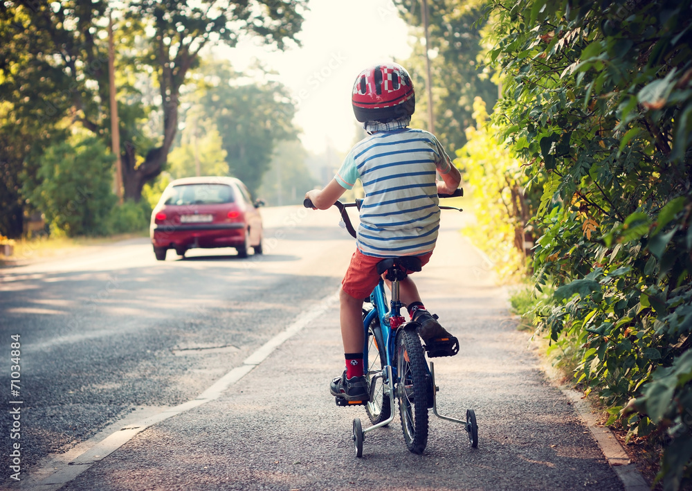 Boy on bike on sidewalk