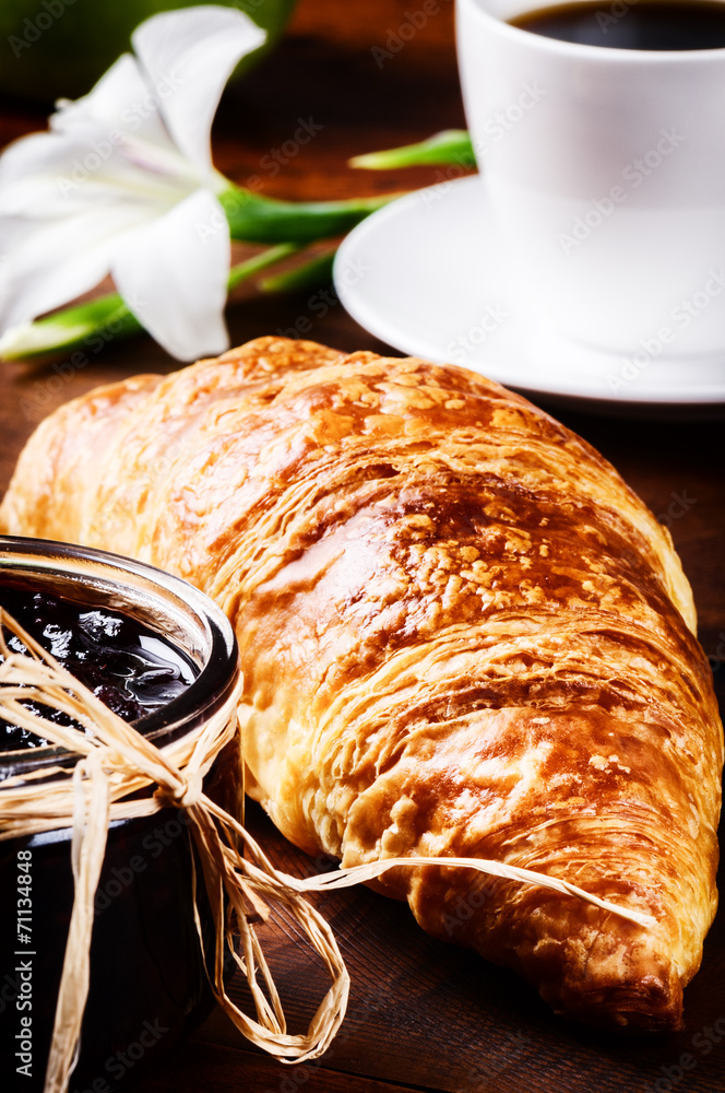 Breakfast with coffee and fresh croissant with jam