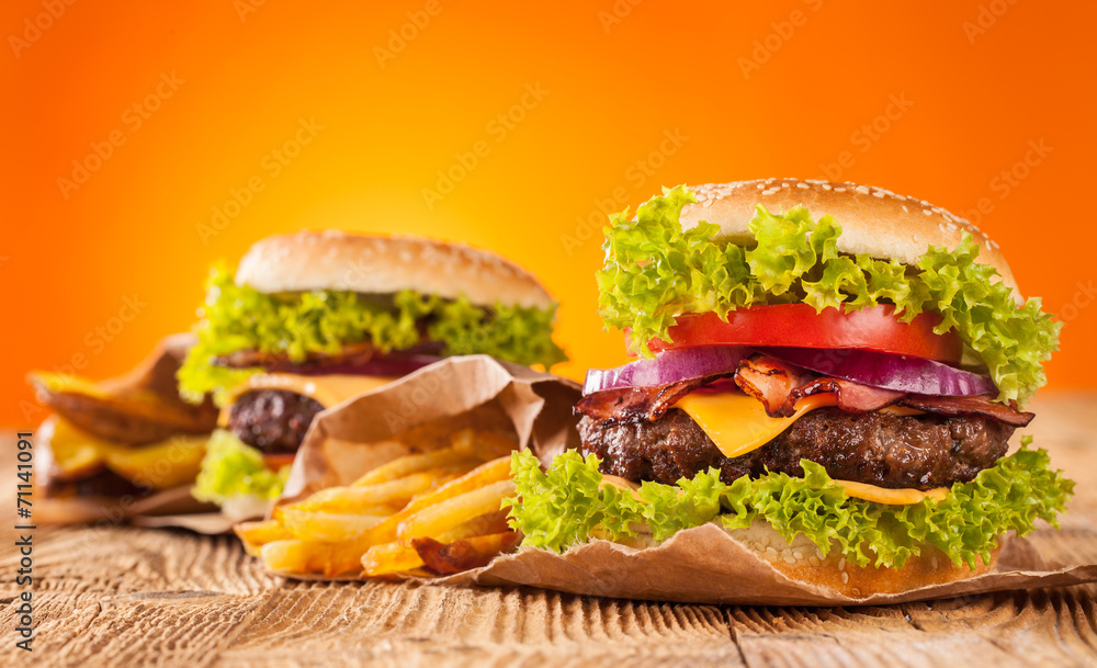 Fresh hamburgers on wooden planks