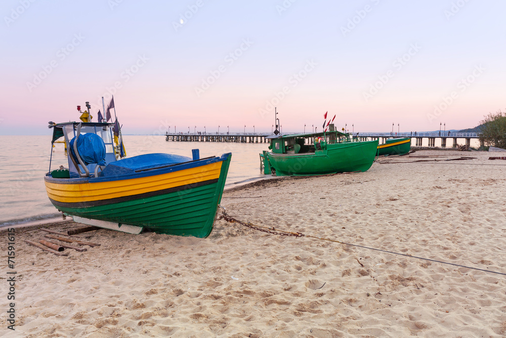 Baltic beach with fishing boat at sunset, Poland