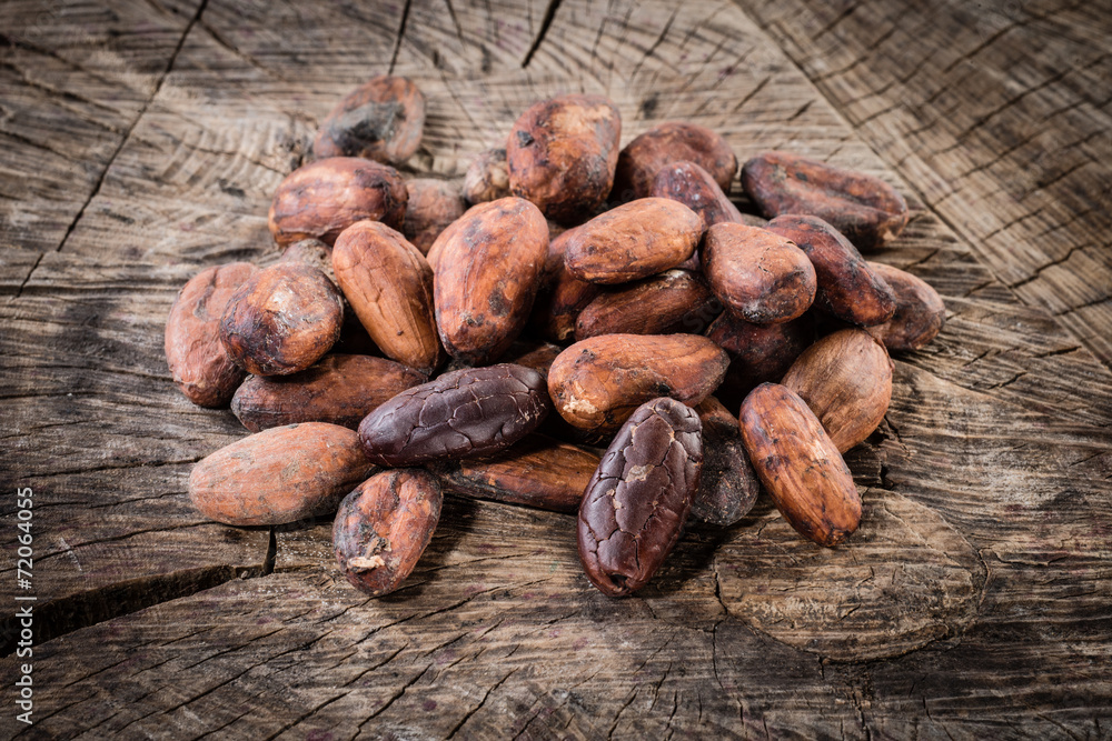 Cocoa beans on wooden background. Organic food