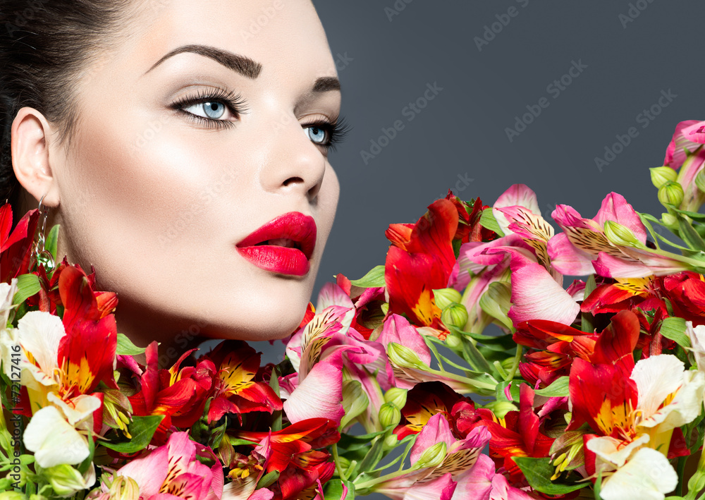 High fashion model girl with colorful flowers and red lips