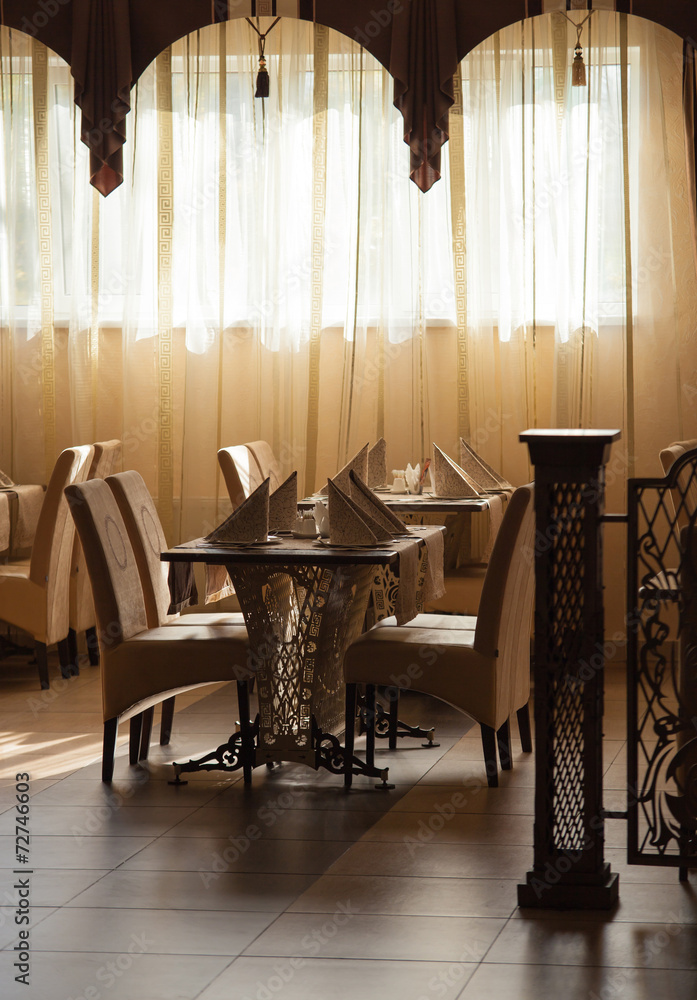 Restaurant tables near the bright window