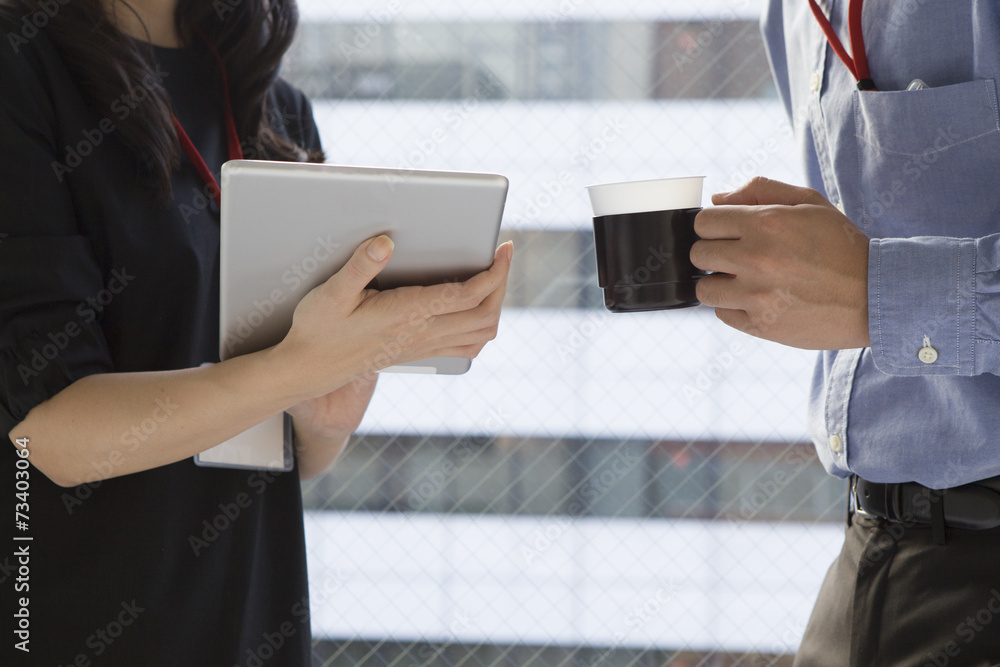 Men and women that are looking at the tablet