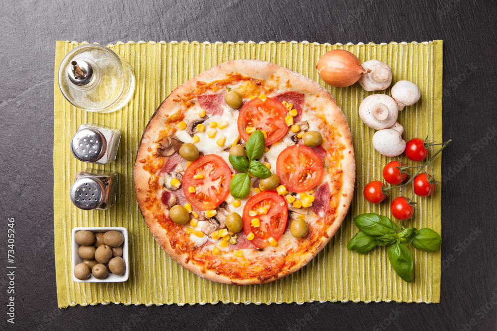 Delicious fresh pizza served on black stone