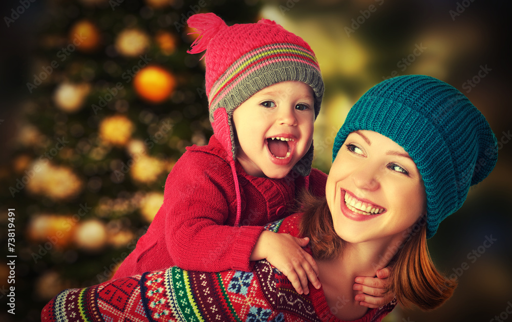 happy family mother and little daughter playing in Christmas