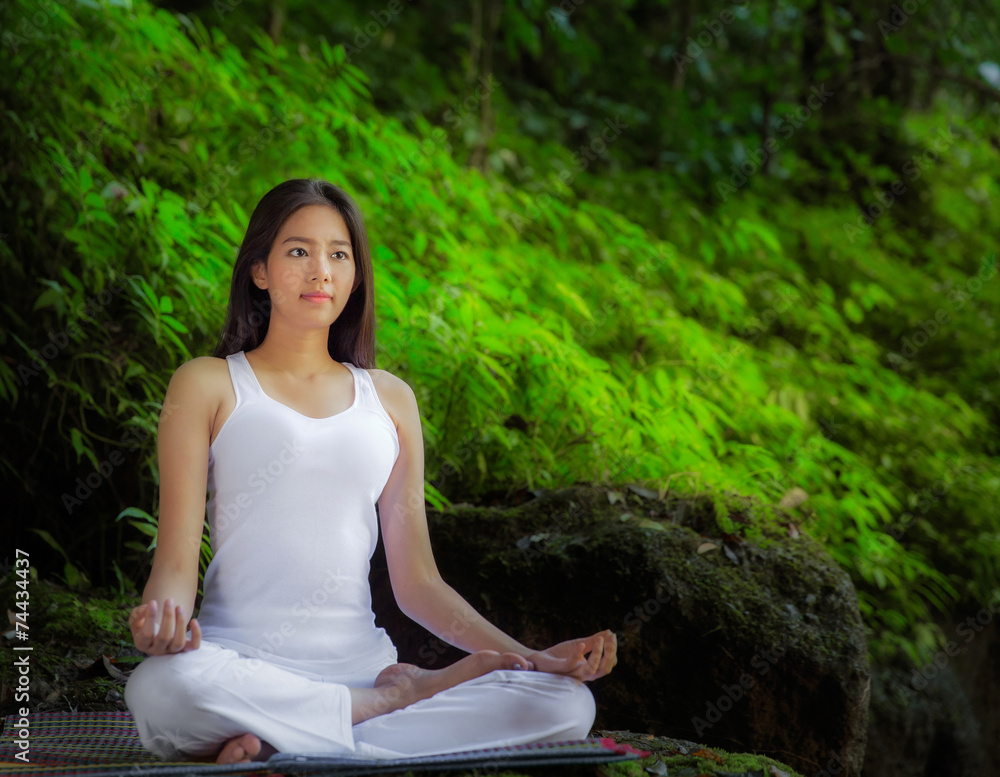 Asian pretty woman doing yoga exercises