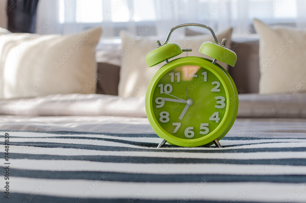 modern green alarm clock in bedroom