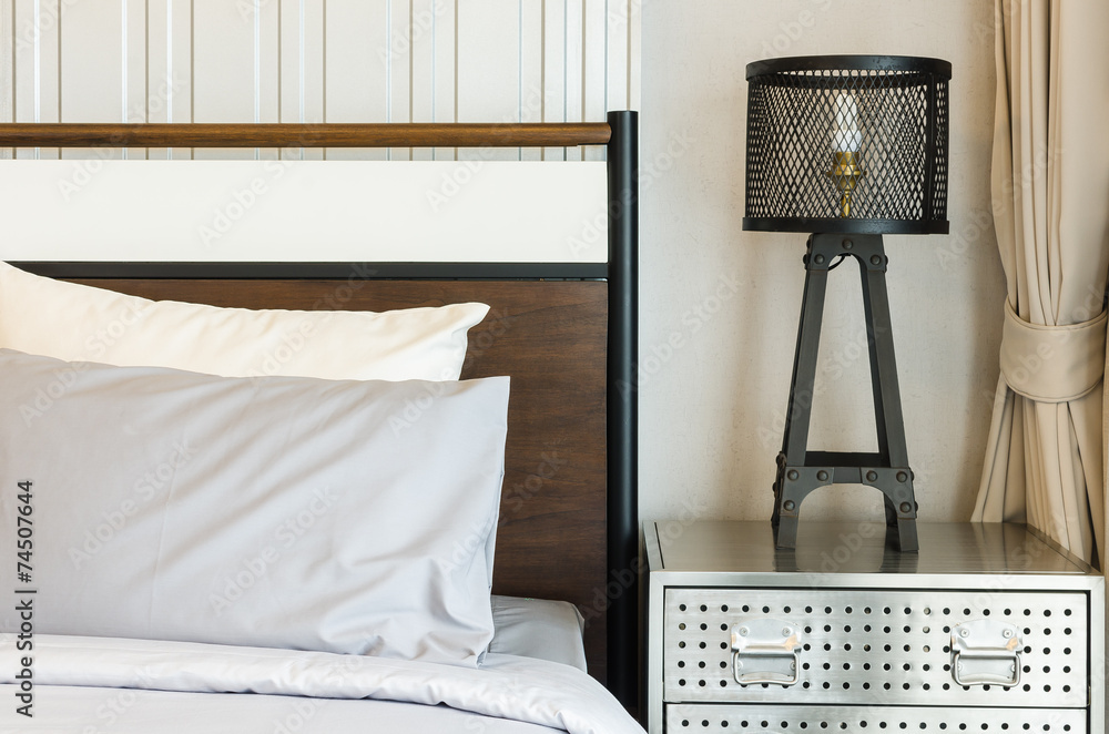 pillows on bed with modern lamp