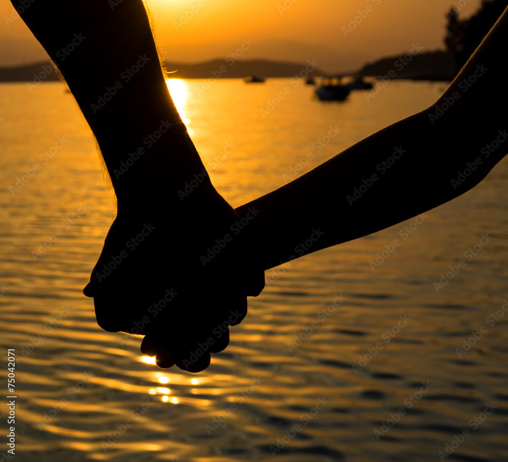 Father and little daughter holding each other hands