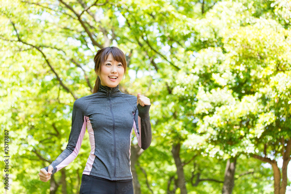 young asian woman running in the park