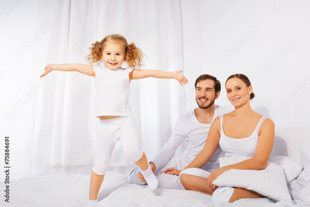 Father, mother and their cute daughter playing