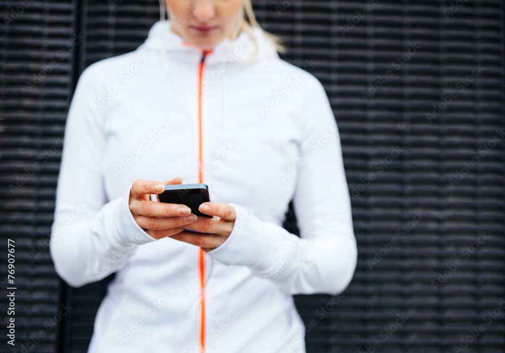 Woman in sportswear using mobile phone