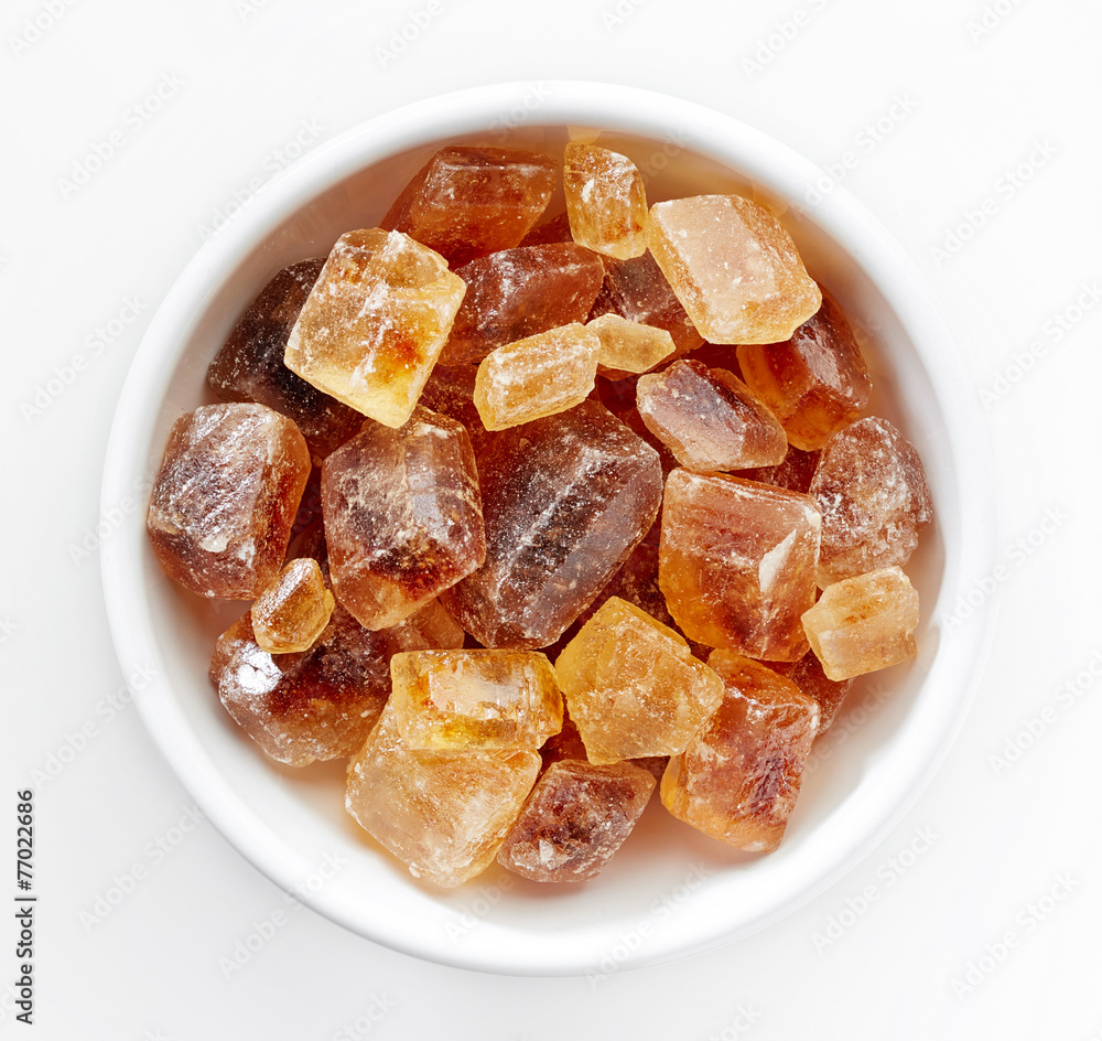 Brown caramelized sugar cubes on a white background