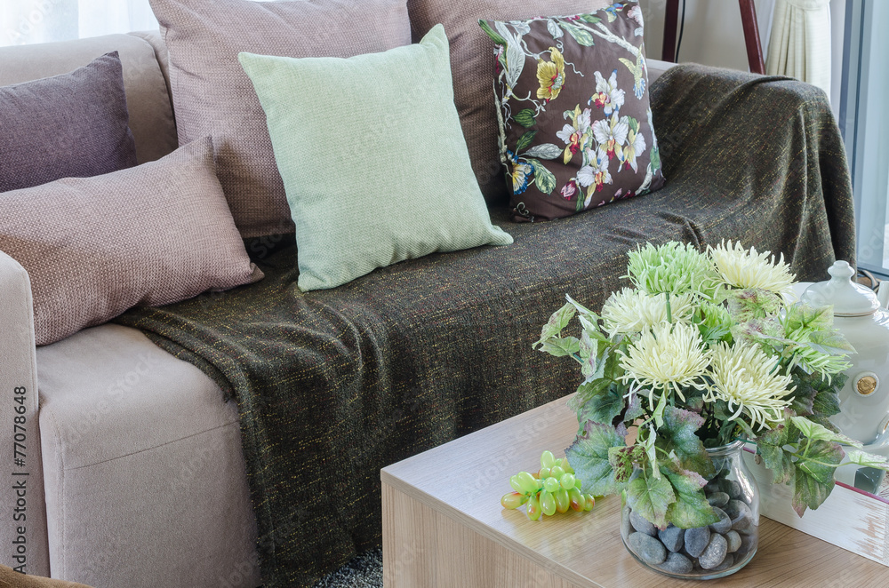 plant in glass vase on wooden table in living room