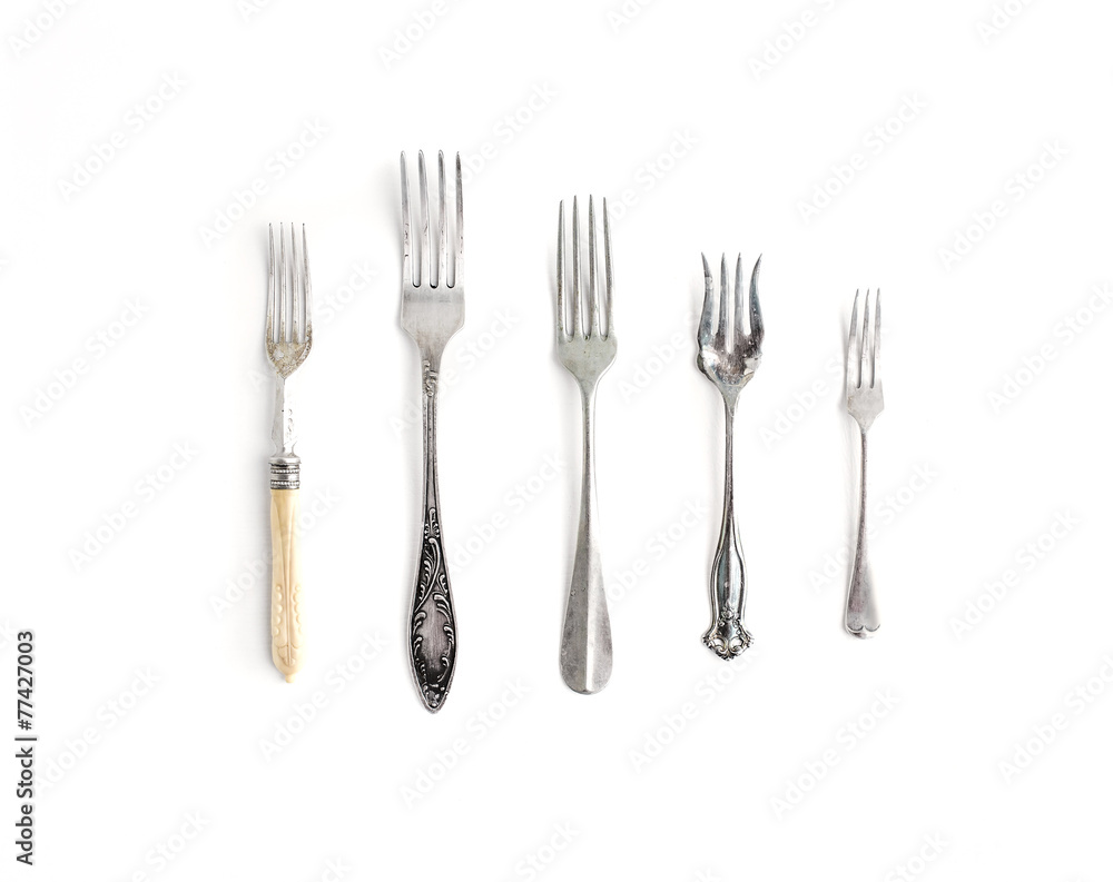 A set of vintage dinnerware: forks of different shapes and sizes