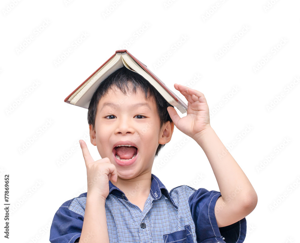 Asian boy with book on head thinking over white background