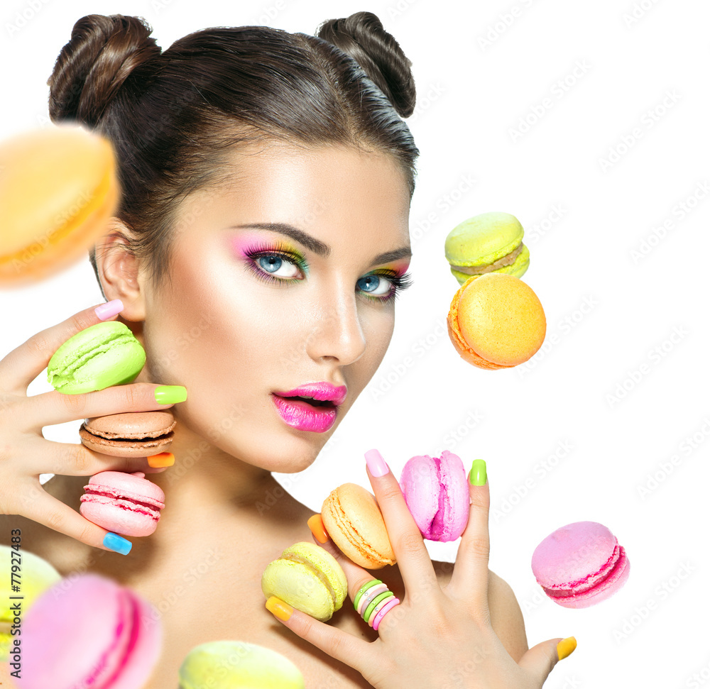 Beauty fashion model girl taking colorful macaroons