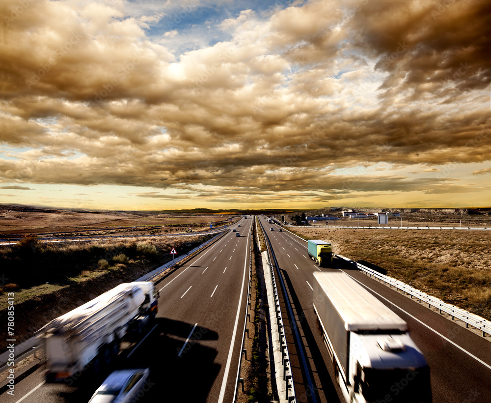 Camiones y coches en la carretera. Logística y almacenaje