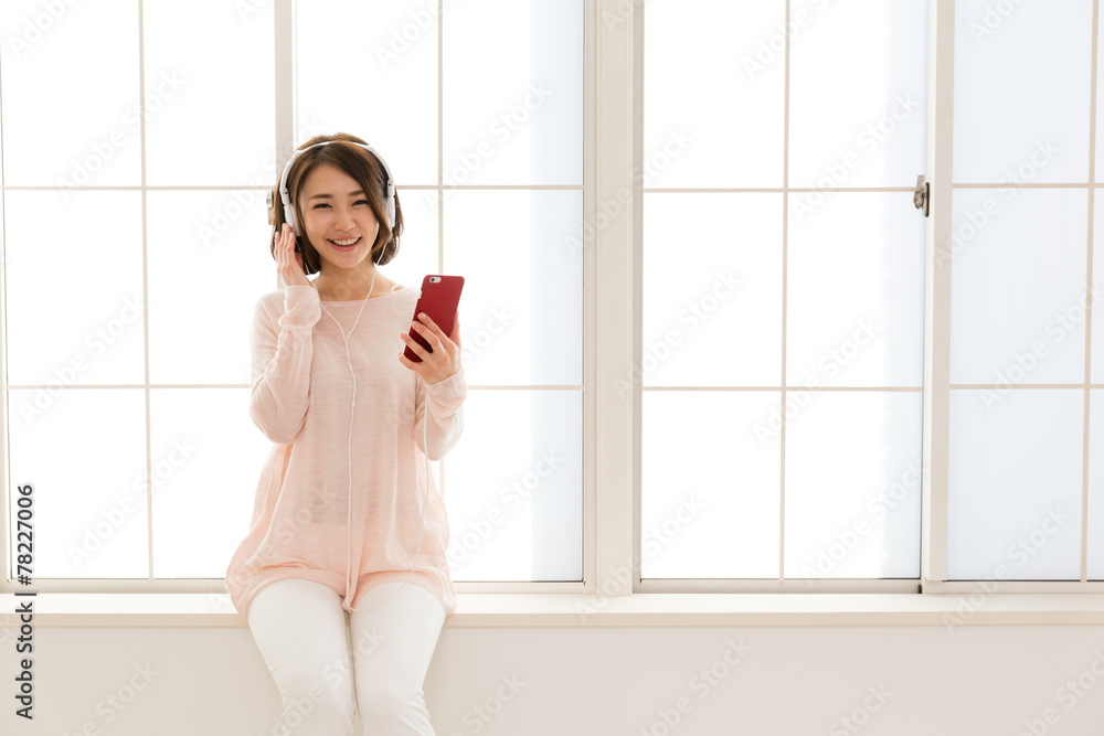 young asian woman listening music