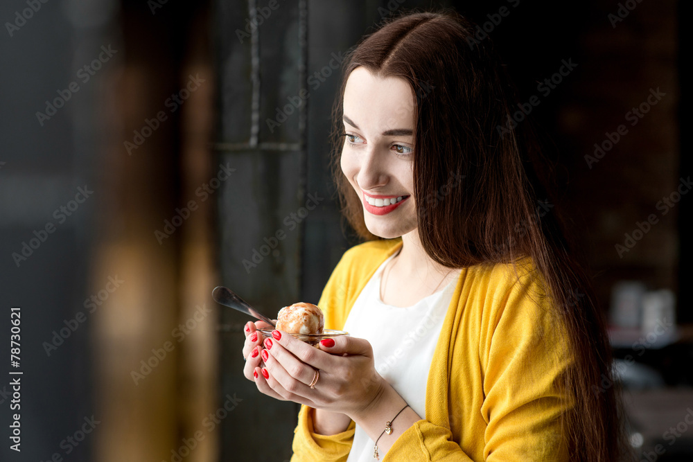 Woman eating ice cream in the cafe