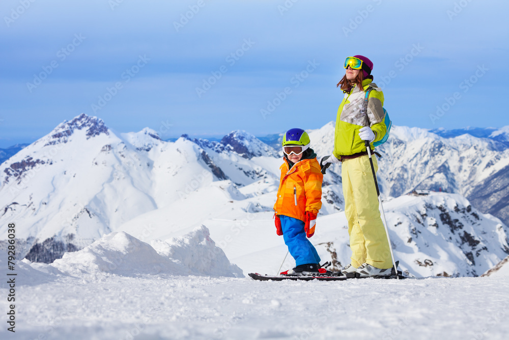 Ski vacation in mountains, woman and child happy