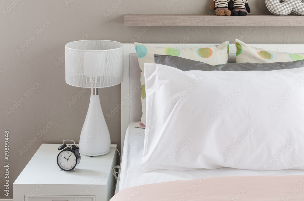 kids bedroom with white pillows and lamp on modern bed