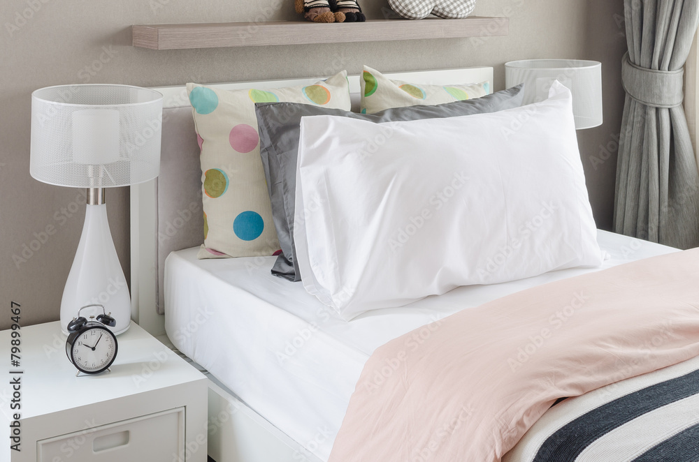 kids bedroom with white pillows and lamp on modern bed