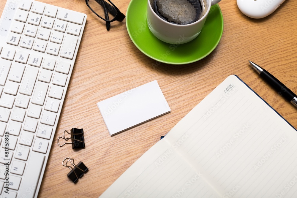 Desktop. Tablet, notepad, glasses and coffee cup on office