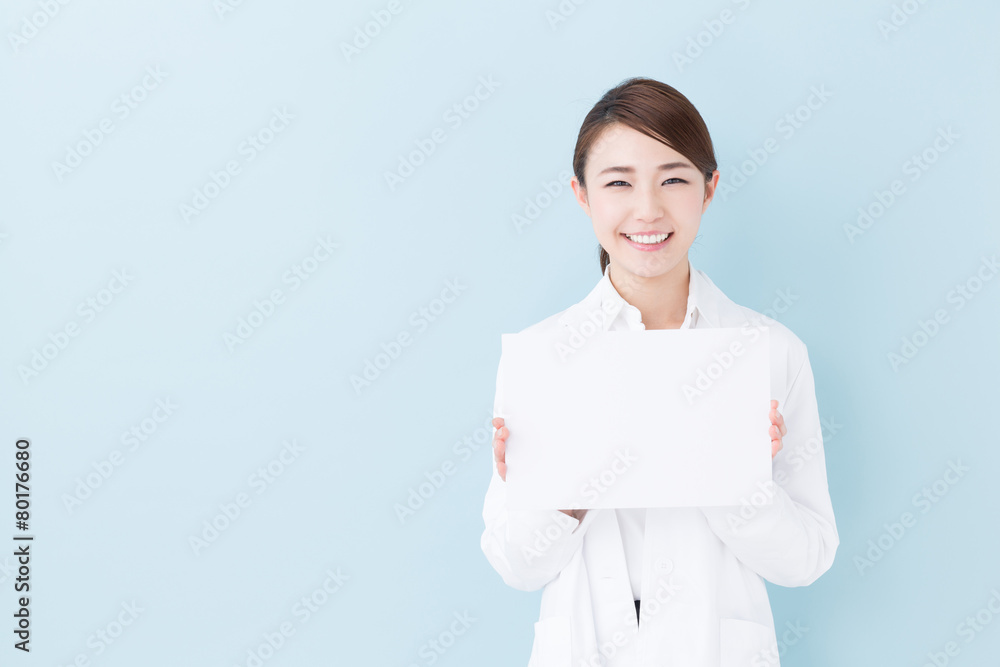 young asian doctor on blue background