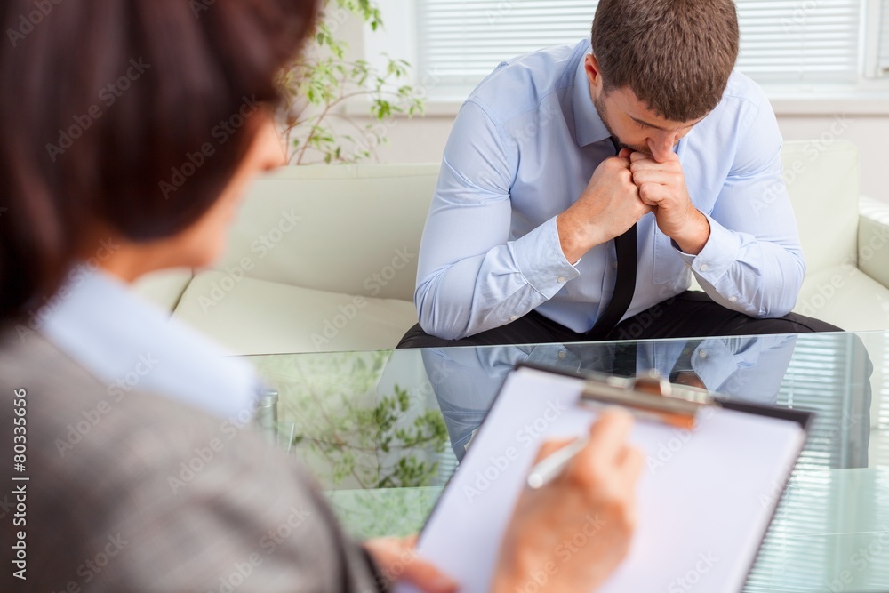 Session. Female psychologist consulting pensive man during