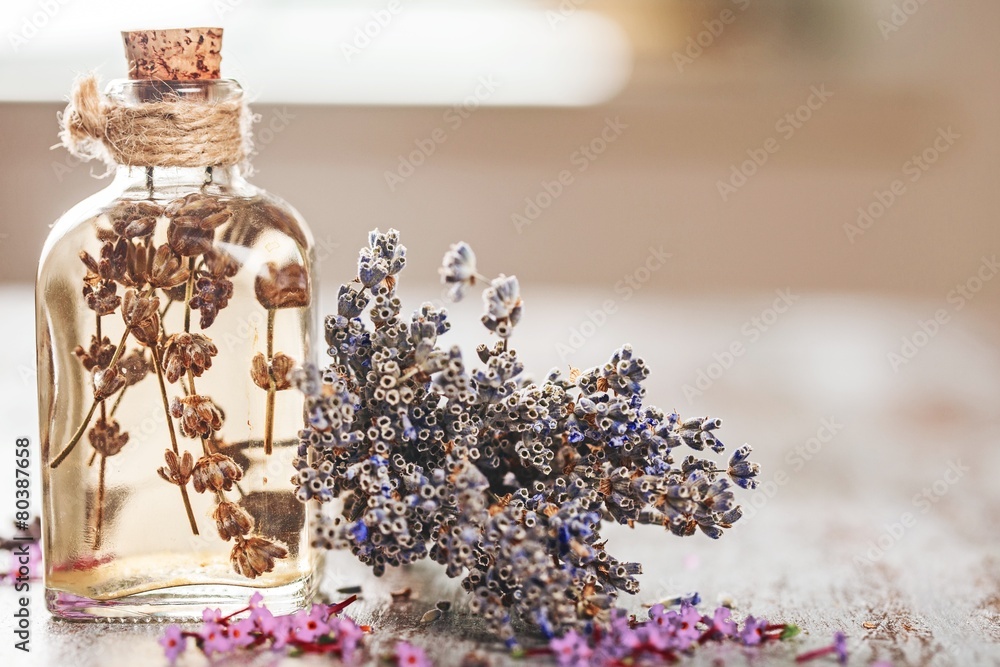 Oil. bottle of lavender oil with fresh flowers on wooden