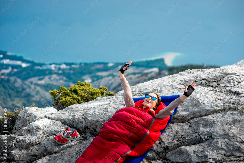 Woman in sleeping bag on the mountain