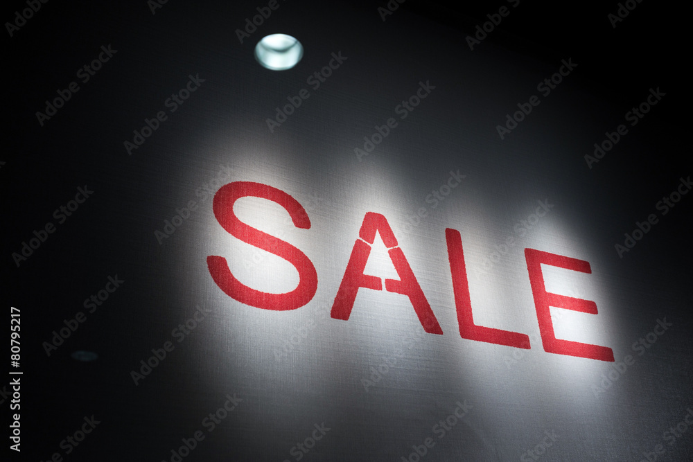 illuminated word sale in dark shopfront