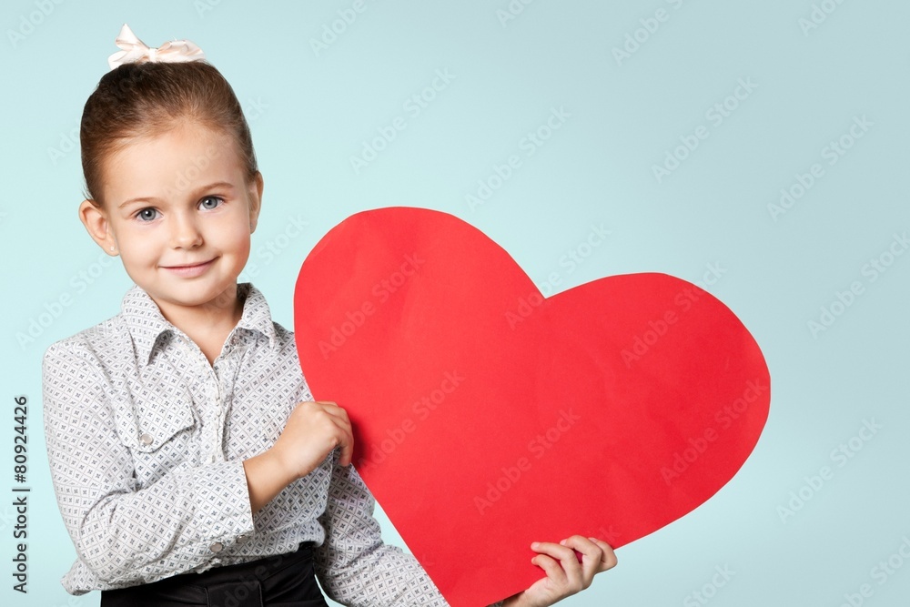 Child. Little girl holding red heart, close-up isolated on white