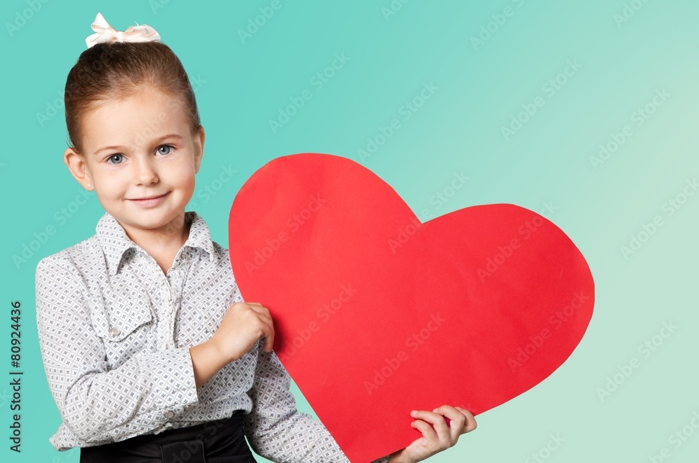 Child. Little girl holding red heart, close-up isolated on white