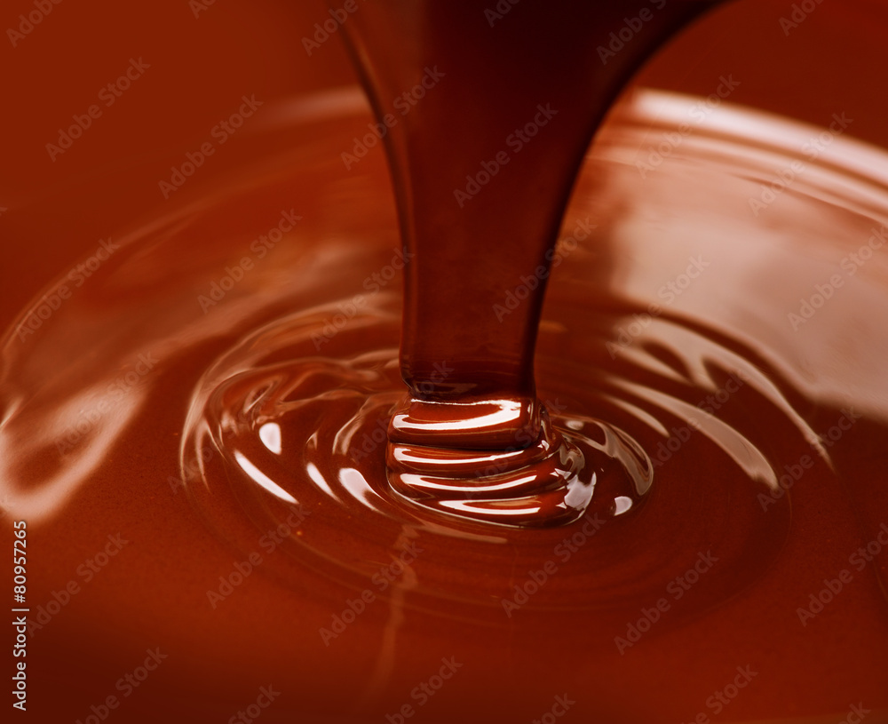 Chocolate flow. Close up of liquid hot chocolate pouring closeup