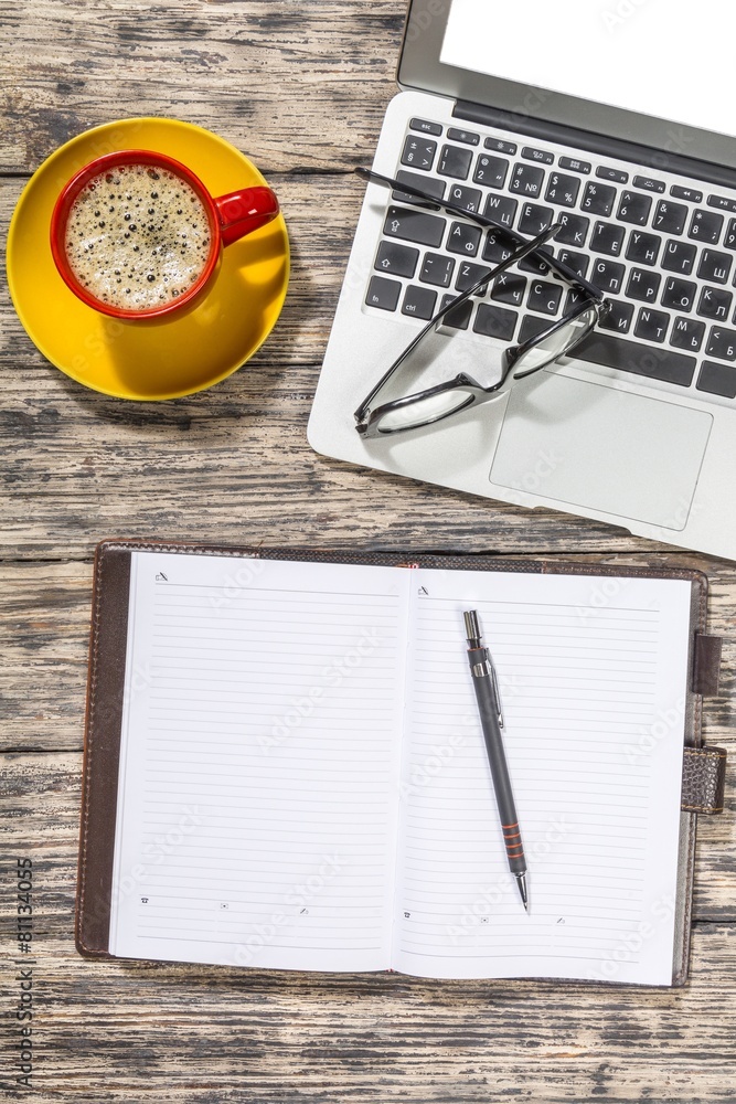 Glasses. Cup of coffee and laptop with a pair of hipster glasses