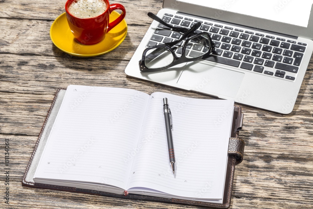 Glasses. Cup of coffee and laptop with a pair of hipster glasses